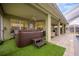 Hot tub on patio with artificial turf and adjacent seating at 111 Vista Dr, Davenport, FL 33897