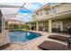 Inviting pool area with a screened enclosure and patio furniture at 111 Vista Dr, Davenport, FL 33897