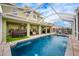 Spacious pool with screened enclosure, hot tub, and patio furniture at 111 Vista Dr, Davenport, FL 33897