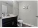Small bathroom with dark vanity and toilet at 11868 Pulitzer Pl, Orlando, FL 32832