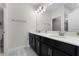 Bathroom with dark vanity, double sinks, and modern light fixtures at 11868 Pulitzer Pl, Orlando, FL 32832