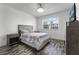 Bedroom with wood-look floors, neutral decor, and plenty of natural light at 11868 Pulitzer Pl, Orlando, FL 32832