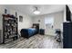 Bedroom with wood-look floors, a twin bed, and built-in shelving at 11868 Pulitzer Pl, Orlando, FL 32832