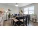 Dining area with dark wood table and chairs, adjacent to kitchen at 11868 Pulitzer Pl, Orlando, FL 32832