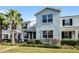 Two-story light blue home with palm trees and landscaping at 11868 Pulitzer Pl, Orlando, FL 32832