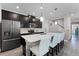 Modern kitchen with dark cabinetry, white countertops, and island seating at 11868 Pulitzer Pl, Orlando, FL 32832