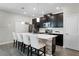 Modern kitchen with dark cabinetry, white countertops, and island seating at 11868 Pulitzer Pl, Orlando, FL 32832