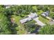 Aerial view of a large home with lush landscaping, a winding driveway, and metal roof at 12788 Gillard Rd, Winter Garden, FL 34787
