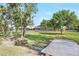 Peaceful backyard view of lush lawn, mature trees, and small stream flowing into pond at 12788 Gillard Rd, Winter Garden, FL 34787