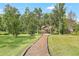 Backyard garden path leading to a gazebo with beautiful landscaping at 12788 Gillard Rd, Winter Garden, FL 34787