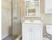Modern bathroom with a glass shower, white vanity, and neutral tile at 12788 Gillard Rd, Winter Garden, FL 34787