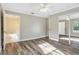 Bedroom with hard wood floors, an open bathroom entrance, and a mirrored closet at 12788 Gillard Rd, Winter Garden, FL 34787