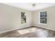 Bedroom featuring wood floors, neutral walls, and a beautiful view of the backyard at 12788 Gillard Rd, Winter Garden, FL 34787