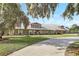 A charming brick home with a light-colored metal roof, brick pathway and lush green lawn and landscaping at 12788 Gillard Rd, Winter Garden, FL 34787