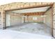 Spacious two car garage interior featuring a white door, painted walls, and overhead storage at 12788 Gillard Rd, Winter Garden, FL 34787