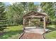Garden gazebo with red plants, landscape, and pine straw base at 12788 Gillard Rd, Winter Garden, FL 34787