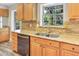 Kitchen with stainless steel appliances, wood cabinets, and a large sink with a view at 12788 Gillard Rd, Winter Garden, FL 34787