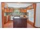 Kitchen features center island, modern appliances, wood cabinets and tiled backsplash at 12788 Gillard Rd, Winter Garden, FL 34787