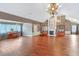 Expansive living room featuring hardwood floors, fireplace, and bright chandelier lighting at 12788 Gillard Rd, Winter Garden, FL 34787