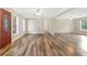 A neutral, airy living space with modern floors, an exterior door, and a unique spiral staircase at 12788 Gillard Rd, Winter Garden, FL 34787