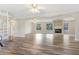 A bright, open-concept living space with a fireplace, modern ceiling fans, and wood-look floors at 12788 Gillard Rd, Winter Garden, FL 34787