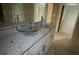 Bathroom with double sinks, granite countertop, and glass bowls at 1450 Warrior Trl, Deltona, FL 32725