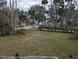 View of a cleared lot with mature trees and neighboring houses visible at 1450 Warrior Trl, Deltona, FL 32725