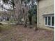 Two-story house exterior with stone and stucco siding, screened porch, and lush landscaping at 1450 Warrior Trl, Deltona, FL 32725