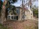 Two-story house exterior showcasing stone and stucco siding, multiple windows, and a staircase at 1450 Warrior Trl, Deltona, FL 32725