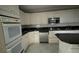 Kitchen with white cabinets, granite countertops, and stainless steel appliances at 1450 Warrior Trl, Deltona, FL 32725