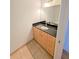 Modern bathroom with dark countertop and light wood cabinets at 150 E Robinson St # 1411, Orlando, FL 32801