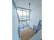 High-ceilinged living room with hardwood floors, floor-to-ceiling windows, and spiral staircase at 150 E Robinson St # 1411, Orlando, FL 32801