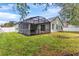 Large backyard with screened patio and lush grass at 15336 Firelight Dr, Winter Garden, FL 34787