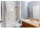 Clean bathroom with tub shower, wood vanity, and neutral tile at 15336 Firelight Dr, Winter Garden, FL 34787
