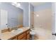 Simple bathroom with wood vanity, beige tile, and a bathtub at 15336 Firelight Dr, Winter Garden, FL 34787