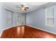 Spacious bedroom with hardwood floors, ceiling fan, and access to backyard at 15336 Firelight Dr, Winter Garden, FL 34787