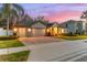 Two-story home with a two-car garage and manicured lawn at 15336 Firelight Dr, Winter Garden, FL 34787