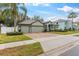 Landscaped yard and a three-car garage at 15336 Firelight Dr, Winter Garden, FL 34787