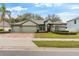 Two-story house with a three-car garage and landscaped yard at 15336 Firelight Dr, Winter Garden, FL 34787
