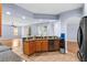 Open kitchen with granite countertops, wood cabinets, and breakfast bar at 15336 Firelight Dr, Winter Garden, FL 34787
