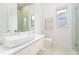 Clean bathroom with a floating vanity and a frameless shower at 16106 Pendio Dr, Bella Collina, FL 34756