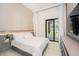 Bright bedroom with sliding glass doors opening to a patio at 16106 Pendio Dr, Bella Collina, FL 34756