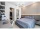 Bright bedroom with a comfortable bed, built-in desk, and en-suite bathroom at 16106 Pendio Dr, Bella Collina, FL 34756