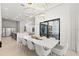 Modern dining room with a large marble table and statement lighting at 16106 Pendio Dr, Bella Collina, FL 34756