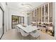 Elegant dining room with marble table and modern chandelier at 16106 Pendio Dr, Bella Collina, FL 34756