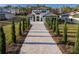 Modern home with long driveway and landscaping at 16106 Pendio Dr, Bella Collina, FL 34756