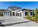 Two-story house with a three-car garage and a paver driveway at 16106 Pendio Dr, Bella Collina, FL 34756