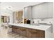 Modern kitchen with white cabinets, a large island, and wine storage at 16106 Pendio Dr, Bella Collina, FL 34756