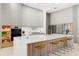 Modern kitchen with white and wood cabinets and a large island at 16106 Pendio Dr, Bella Collina, FL 34756