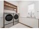 Modern laundry room with washer, dryer, and additional storage at 16106 Pendio Dr, Bella Collina, FL 34756